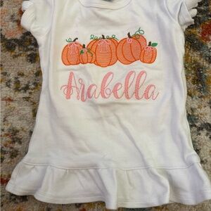 “Arabella” White T-Shirt with Orange Pumpkin Design